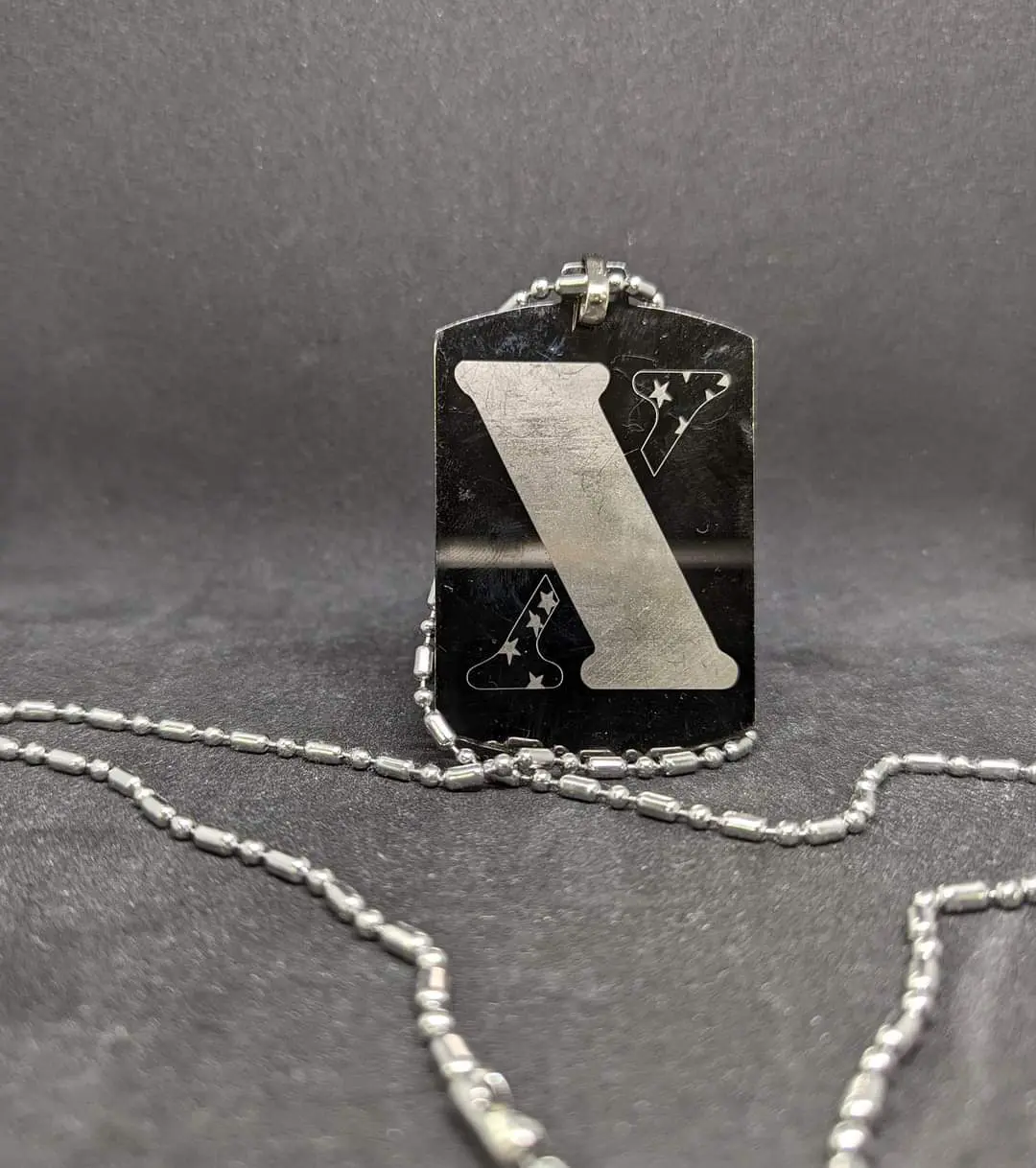 A dog tag with the letter z on it.